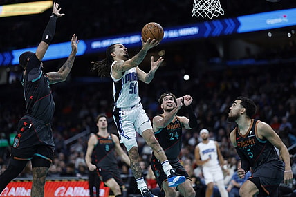 Dec 26, 2023; Washington, District of Columbia, USA; Orlando Magic guard Cole Anthony (50) shoots the ball as Washington Wizards center Daniel Gafford (21) defends in the second quarter at Capital One Arena. Mandatory Credit: Geoff Burke-USA TODAY Sports