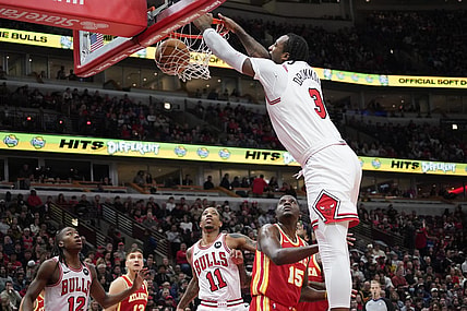 Dec 26, 2023; Chicago, Illinois, USA; Chicago Bulls center Andre Drummond (3) dunks the ball over Atlanta Hawks center Clint Capela (15) during the first quarter at United Center. Mandatory Credit: David Banks-USA TODAY Sports