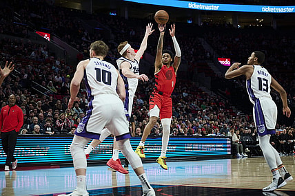 Dec 26, 2023; Portland, Oregon, USA; Portland Trail Blazers guard Anfernee Simons (1) shoots a jump shot against Sacramento Kings guard Kevin Huerter (9) during the first half at Moda Center. Mandatory Credit: Troy Wayrynen-USA TODAY Sports