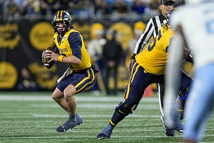 Dec 27, 2023; Charlotte, NC, USA; West Virginia Mountaineers quarterback Garrett Greene (6) in action during the first half at Bank of America Stadium. Mandatory Credit: Jim Dedmon-USA TODAY Sports