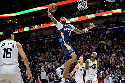 Dec 28, 2023; New Orleans, Louisiana, USA; New Orleans Pelicans forward Brandon Ingram (14) dunks against Utah Jazz guard Jordan Clarkson (00) during the first quarter at the Smoothie King Center. Mandatory Credit: Matthew Hinton-USA TODAY Sports