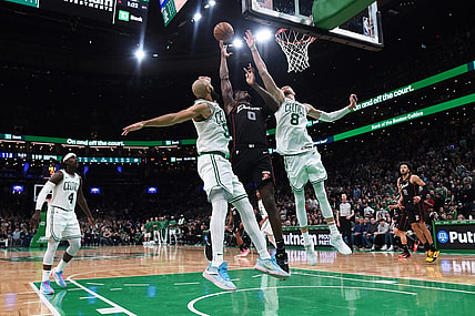 Dec 28, 2023; Boston, Massachusetts, USA;  Boston Celtics guard Derrick White (9) Detroit Pistons center Jalen Duren (0) and center Kristaps Porzingis (8) battle for a rebound during overtime at TD Garden. Mandatory Credit: Bob DeChiara-USA TODAY Sports