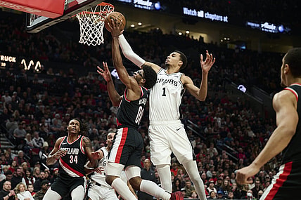 Dec 28, 2023; Portland, Oregon, USA; San Antonio Spurs center Victor Wembanyama (1) blocks a shot during the first half against Portland Trail Blazers guard Scoot Henderson (00) at Moda Center. Mandatory Credit: Troy Wayrynen-USA TODAY Sports