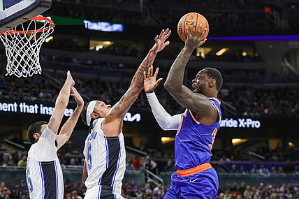 Dec 29, 2023; Orlando, Florida, USA; New York Knicks forward Julius Randle (30) shoots against Orlando Magic forward Paolo Banchero (5) during the first quarter at KIA Center. Mandatory Credit: Mike Watters-USA TODAY Sports