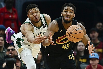 Dec 29, 2023; Cleveland, Ohio, USA; Milwaukee Bucks forward Giannis Antetokounmpo (34) and Cleveland Cavaliers guard Donovan Mitchell (45) go for a loose ball during the first half at Rocket Mortgage FieldHouse. Mandatory Credit: Ken Blaze-USA TODAY Sports