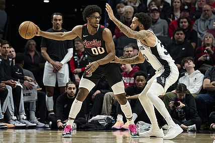 Dec 29, 2023; Portland, Oregon, USA; Portland Trail Blazers guard Scoot Henderson (00) looks to pass the ball during the first half against San Antonio Spurs forward Julian Champagnie (30) at Moda Center. Mandatory Credit: Troy Wayrynen-USA TODAY Sports