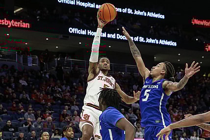 Dec 30, 2023; Elmont, New York, USA;  St. John's Red Storm guard Daniss Jenkins (5) shoots past Hofstra Pride guard Jaquan Carlos (5) in the second half at UBS Arena. Mandatory Credit: Wendell Cruz-USA TODAY Sports