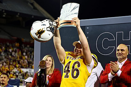 Dec 30, 2023; Tucson, AZ, USA; Wyoming Cowboys place kicker John Hoyland (46) celebrates with offensive MVP trophy after the Wyoming Cowboys beat the Toledo Rockets in the Arizona Bowl at Arizona Stadium. Mandatory Credit: Mark J. Rebilas-USA TODAY Sports