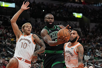 Dec 31, 2023; San Antonio, Texas, USA;  Boston Celtics guard Jaylen Brown (7) loses the ball in front of San Antonio Spurs forwards Jeremy Sochan (10) Julian Champagnie (30) in the first half at Frost Bank Center. Mandatory Credit: Daniel Dunn-USA TODAY Sports