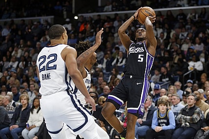 Dec 31, 2023; Memphis, Tennessee, USA; Sacramento Kings guard De'Aaron Fox (5) shoots as Memphis Grizzlies guard Marcus Smart (36) defends during the first half at FedExForum. Mandatory Credit: Petre Thomas-USA TODAY Sports
