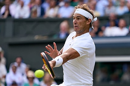 Jul 6, 2022; London, England, United Kingdom; Rafael Nadal (ESP) returns a shot during his quarter finals men s singles match against Taylor Fritz (USA) on Centre court at All England Lawn Tennis and Croquet Club. Mandatory Credit: Peter van den Berg-USA TODAY Sports