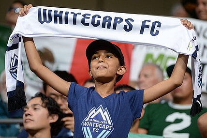 Jul 21, 2023; Vancouver, British Columbia, CAN; A young Vancouver Whitecaps fan is seen holding a scarf during the second half between the Vancouver Whitecaps and Club Leon at BC Place. Mandatory Credit: Anne-Marie Sorvin-USA TODAY Sports