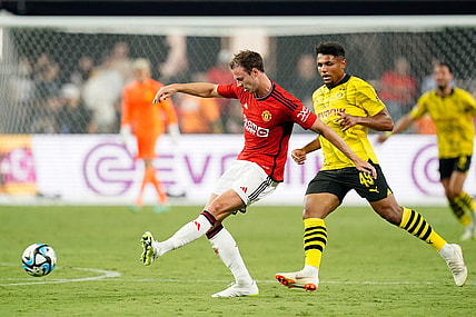 Jul 30, 2023; Las Vegas, Nevada, USA; Manchester United defender Jonny Evans (27) kicks the ball against Borussia Dortmund forward Paul-Phillip Besong (49) during the second half at Allegiant Stadium. Mandatory Credit: Lucas Peltier-USA TODAY Sports