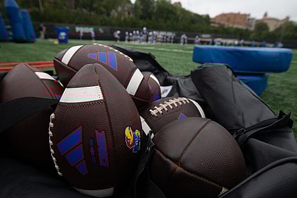 Kansas practice footballs are seen in an equipment bag at Monday's practice.