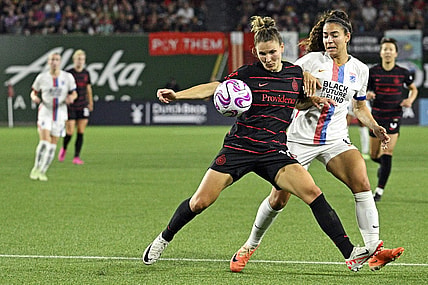 Sep 16, 2023; Portland, Oregon, USA; Portland Thorns FC defender Natalia Kuikka (14) moves the ball against OL Reign midfielder Angelina (6) at Providence Park. Mandatory Credit: Troy Wayrynen-USA TODAY Sports