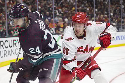 Oct 15, 2023; Anaheim, California, USA; Anaheim Ducks center Bo Groulx (24) makes a play against Carolina Hurricanes defensemen Brent Burns (8) in the third period at Honda Center. Mandatory Credit: Yannick Peterhans-USA TODAY Sports