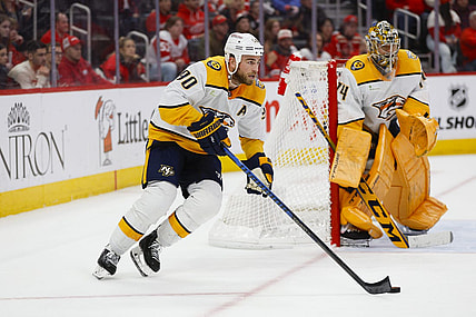 Dec 29, 2023; Detroit, Michigan, USA; Nashville Predators center Ryan O'Reilly (90) handles the puck during an overtime period of the game between the Detroit Red Wings and the Nashville Predators at Little Caesars Arena. Mandatory Credit: Brian Bradshaw Sevald-USA TODAY Sports