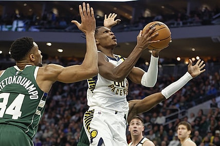 Jan 1, 2024; Milwaukee, Wisconsin, USA; Indiana Pacers guard Bennedict Mathurin (00) goes to the basket against Milwaukee Bucks forward Giannis Antetokounmpo (34) during the second half at Fiserv Forum. Mandatory Credit: Kamil Krzaczynski-USA TODAY Sports