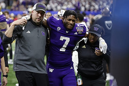 Jan 1, 2024; New Orleans, LA, USA; Washington Huskies running back Dillon Johnson (7) is helped into the medical examination tent after being injured against the Texas Longhorns in the 2024 Sugar Bowl college football playoff semifinal game at Caesars Superdome. Mandatory Credit: Geoff Burke-USA TODAY Sports