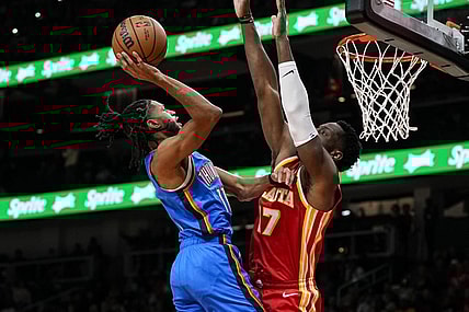 Jan 3, 2024; Atlanta, Georgia, USA; Oklahoma City Thunder guard Isaiah Joe (11) shoots against Atlanta Hawks forward Onyeka Okongwu (17) during the first half at State Farm Arena. Mandatory Credit: Dale Zanine-USA TODAY Sports