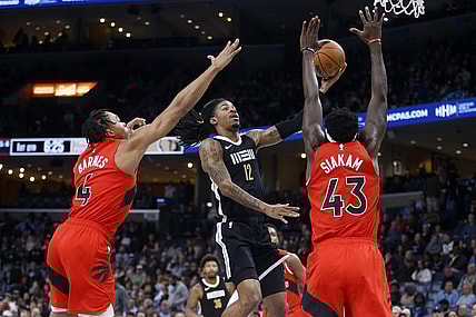 Jan 3, 2024; Memphis, Tennessee, USA; Memphis Grizzlies guard Ja Morant (12) drives to the basket between Toronto Raptors forward Scottie Barnes (4) and forward Pascal Siakam (43) during the first half at FedExForum. Mandatory Credit: Petre Thomas-USA TODAY Sports