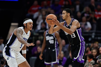 Jan 3, 2024; Sacramento, California, USA; Sacramento Kings forward Keegan Murray (13) looks to pass the ball against Orlando Magic forward Paolo Banchero (5) during the first quarter at Golden 1 Center. Mandatory Credit: Sergio Estrada-USA TODAY Sports