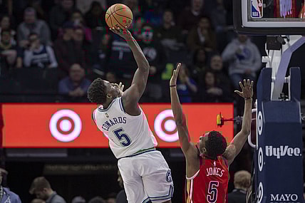 Jan 3, 2024; Minneapolis, Minnesota, USA; Minnesota Timberwolves guard Anthony Edwards (5) shoots the ball over New Orleans Pelicans forward Herbert Jones (5) in the second half at Target Center. Mandatory Credit: Jesse Johnson-USA TODAY Sports