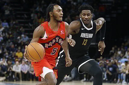 Jan 3, 2024; Memphis, Tennessee, USA; Toronto Raptors guard Immanuel Quickley (5) drives to the basket as Memphis Grizzlies forward-center Jaren Jackson Jr. (13) defends during the second half at FedExForum. Mandatory Credit: Petre Thomas-USA TODAY Sports