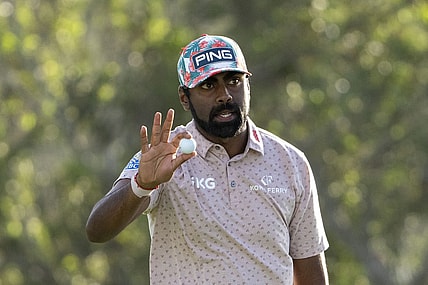 January 4, 2024; Maui, Hawaii, USA; Sahith Theegala acknowledges the crowd after making his putt on the 18th hole during the first round of The Sentry golf tournament at Kapalua Golf - The Plantation Course. Mandatory Credit: Kyle Terada-USA TODAY Sports