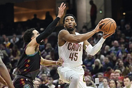 Jan 5, 2024; Cleveland, Ohio, USA; Cleveland Cavaliers guard Donovan Mitchell (45) drives to the basket against Washington Wizards guard Tyus Jones (5) during the first half at Rocket Mortgage FieldHouse. Mandatory Credit: Ken Blaze-USA TODAY Sports