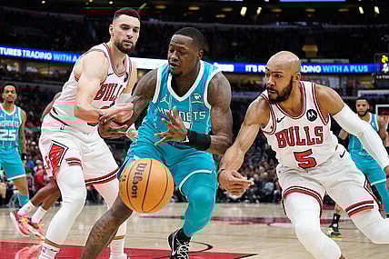 Jan 5, 2024; Chicago, Illinois, USA; Chicago Bulls guard Zach LaVine (8) and guard Jevon Carter (5) defend Charlotte Hornets guard Terry Rozier (3) during the first quarter at United Center. Mandatory Credit: David Banks-USA TODAY Sports