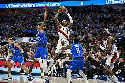Jan 5, 2024; Dallas, Texas, USA; Portland Trail Blazers forward Jerami Grant (9) passes the ball over Dallas Mavericks forward Derrick Jones Jr. (55) and guard Kyrie Irving (11) during the second quarter at the American Airlines Center. Mandatory Credit: Jerome Miron-USA TODAY Sports