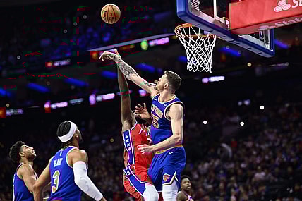 Jan 5, 2024; Philadelphia, Pennsylvania, USA; New York Knicks center Isaiah Hartenstein (55) blocks a shot from Philadelphia 76ers center Joel Embiid (21) in the fourth quarter at Wells Fargo Center. Mandatory Credit: Kyle Ross-USA TODAY Sports