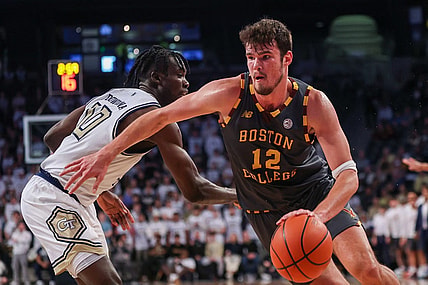 Jan 6, 2024; Atlanta, Georgia, USA; Boston College Eagles forward Quinten Post (12) drives on Georgia Tech Yellow Jackets forward Ebenezer Dowuona (10) in the first half at McCamish Pavilion. Mandatory Credit: Brett Davis-USA TODAY Sports