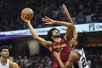 Jan 7, 2024; Cleveland, Ohio, USA; Cleveland Cavaliers center Jarrett Allen (31) shoots beside San Antonio Spurs guard Devin Vassell (24) in the second quarter at Rocket Mortgage FieldHouse. Mandatory Credit: David Richard-USA TODAY Sports