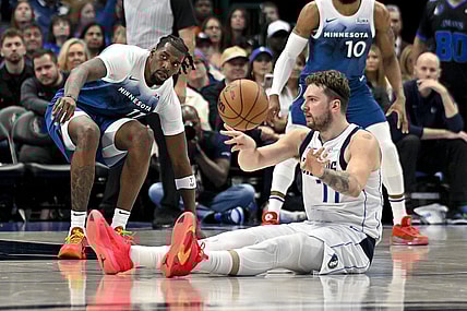 Jan 7, 2024; Dallas, Texas, USA; Dallas Mavericks guard Luka Doncic (77) passes the ball in front of Minnesota Timberwolves center Naz Reid (11) during the second quarter at the American Airlines Center. Mandatory Credit: Jerome Miron-USA TODAY Sports