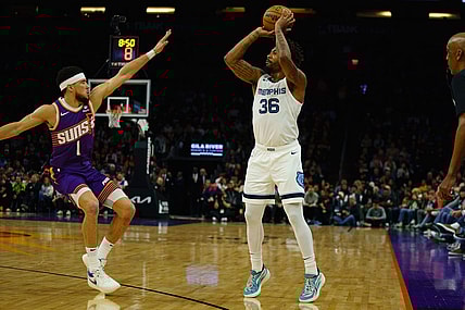 Jan 7, 2024; Phoenix, Arizona, USA;  Memphis Grizzlies guard Marcus Smart (36) squares up against Phoenix Suns guard Devin Booker (1) during the first quarter at Footprint Center. Mandatory Credit: Allan Henry-USA TODAY Sports
