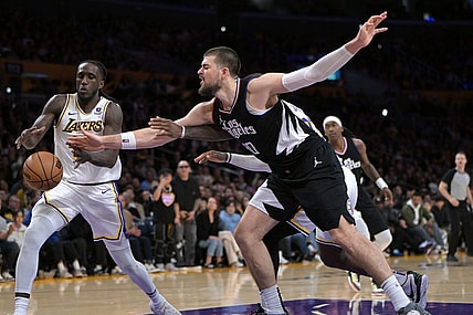 Jan 7, 2024; Los Angeles, California, USA;   Los Angeles Lakers forward Taurean Prince (12) and Los Angeles Clippers center Ivica Zubac (40) reach for a rebound in the second half at Crypto.com Arena. Mandatory Credit: Jayne Kamin-Oncea-USA TODAY Sports