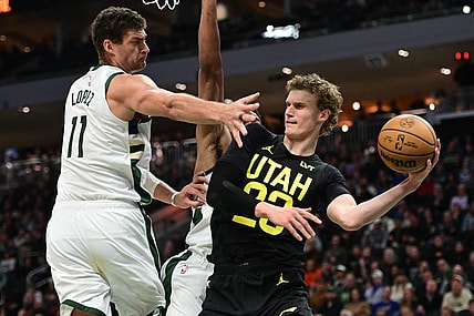 Jan 8, 2024; Milwaukee, Wisconsin, USA;  Utah Jazz forward Lauri Markkanen (23) looks to pass the ball away from Milwaukee Bucks center Brook Lopez (11) in the second quarter at Fiserv Forum. Mandatory Credit: Benny Sieu-USA TODAY Sports