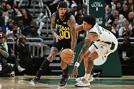 Jan 8, 2024; Milwaukee, Wisconsin, USA; Utah Jazz guard Jordan Clarkson (00) and Milwaukee Bucks guard MarJon Beauchamp (3) reach for a loose ball in the third quarter at Fiserv Forum. Mandatory Credit: Benny Sieu-USA TODAY Sports