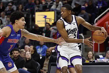 Jan 9, 2024; Detroit, Michigan, USA;  Sacramento Kings guard De'Aaron Fox (5) dribbles defended by Detroit Pistons guard Killian Hayes (7) in the first half at Little Caesars Arena. Mandatory Credit: Rick Osentoski-USA TODAY Sports