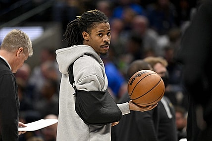 Jan 9, 2024; Dallas, Texas, USA; Memphis Grizzlies guard Ja Morant (12) looks on while wearing his arm in a sling during a time stoppage in the first quarter of the game between the Dallas Mavericks and the Memphis Grizzlies at the American Airlines Center. Mandatory Credit: Jerome Miron-USA TODAY Sports
