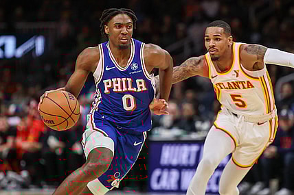 Jan 10, 2024; Atlanta, Georgia, USA; Philadelphia 76ers guard Tyrese Maxey (0) drives on Atlanta Hawks guard Dejounte Murray (5) in the first quarter at State Farm Arena. Mandatory Credit: Brett Davis-USA TODAY Sports