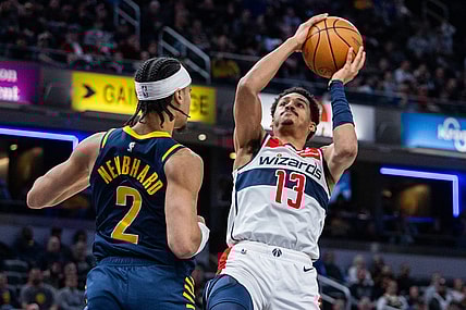 Jan 10, 2024; Indianapolis, Indiana, USA; Washington Wizards guard Jordan Poole (13) shoots the ball while Indiana Pacers guard Andrew Nembhard (2) defends in the first half at Gainbridge Fieldhouse. Mandatory Credit: Trevor Ruszkowski-USA TODAY Sports