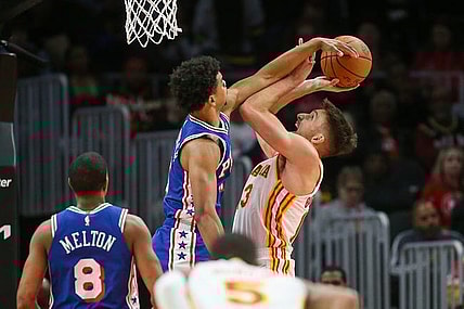 Jan 10, 2024; Atlanta, Georgia, USA; Philadelphia 76ers guard Jaden Springer (11) fouls Atlanta Hawks guard Bogdan Bogdanovic (13) on a block attempt in the second quarter at State Farm Arena. Mandatory Credit: Brett Davis-USA TODAY Sports