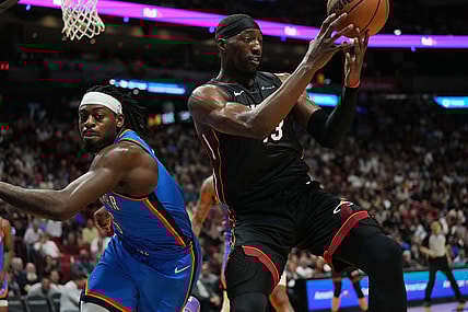 Jan 10, 2024; Miami, Florida, USA; Miami Heat center Bam Adebayo (13) grabs a loose ball as Oklahoma City Thunder guard Luguentz Dort (5) defends during the first half at Kaseya Center. Mandatory Credit: Jim Rassol-USA TODAY Sports