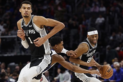 Jan 10, 2024; Detroit, Michigan, USA;  San Antonio Spurs guard Malaki Branham (22) dribbles off the pick by center Victor Wembanyama (1) defended by Detroit Pistons guard Jaden Ivey (23) in the second half at Little Caesars Arena. Mandatory Credit: Rick Osentoski-USA TODAY Sports