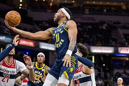 Jan 10, 2024; Indianapolis, Indiana, USA; Indiana Pacers forward Bruce Brown (11) shoots the ball while Washington Wizards forward Deni Avdija (8) defends in the second half at Gainbridge Fieldhouse. Mandatory Credit: Trevor Ruszkowski-USA TODAY Sports