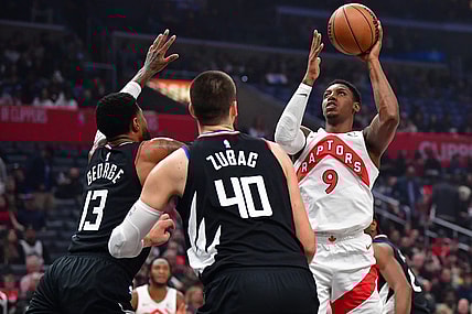 Jan 10, 2024; Los Angeles, California, USA; Toronto Raptors guard RJ Barrett (9) shoots against Los Angeles Clippers forward Paul George (13) and center Ivica Zubac (40) during the first half at Crypto.com Arena. Mandatory Credit: Gary A. Vasquez-USA TODAY Sports