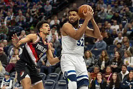 Jan 12, 2024; Minneapolis, Minnesota, USA; Minnesota Timberwolves center Karl-Anthony Towns (32) looks for a teammate defended by Portland Trail Blazers forward Toumani Camara (33) in the first quarter at Target Center. Mandatory Credit: Matt Blewett-USA TODAY Sports